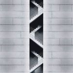 An artistic view of a modern staircase embedded in a concrete building facade in Taipei, Taiwan.