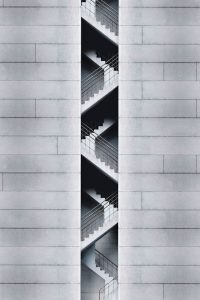An artistic view of a modern staircase embedded in a concrete building facade in Taipei, Taiwan.