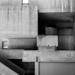 Monochrome image of brutalist architecture featuring concrete geometric forms.