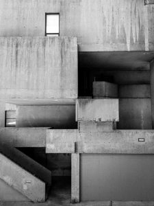 Monochrome image of brutalist architecture featuring concrete geometric forms.